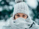 Beautiful young woman wearing scarf and a a hat on a cold winter day